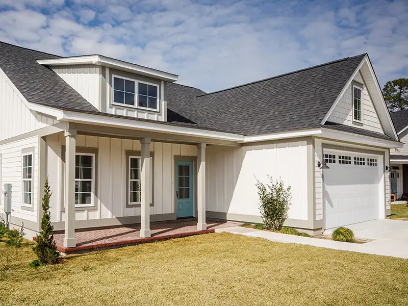 White, modern home with a gray shingle roof